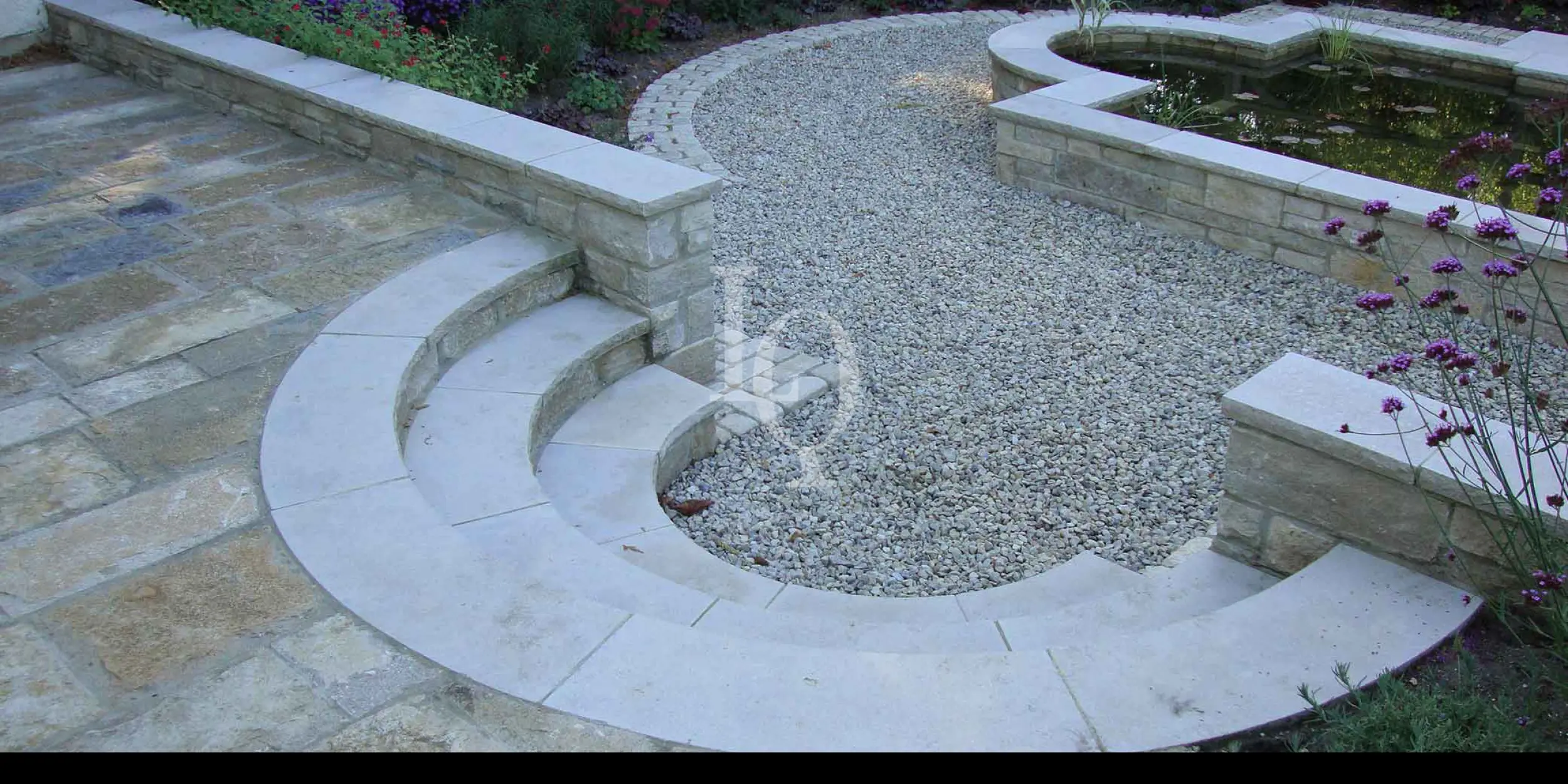 Purbeck limestone curved steps with riven purbeck paving and purbeck chippings